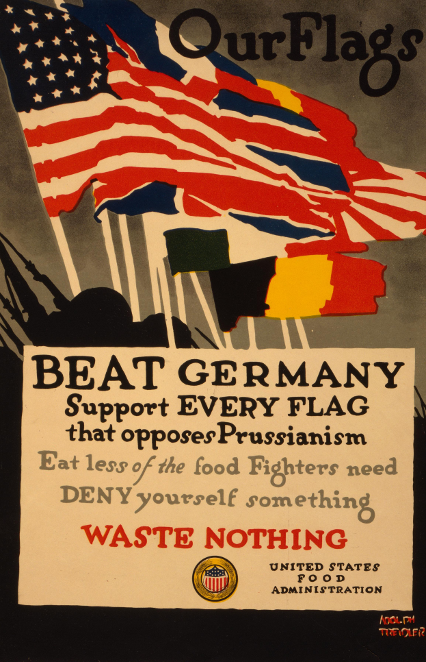 Ein Plakat mit einer roten, weißen und blauen Flagge mit einem weißen Stern und einer schwarzen, fetten Schrift, die lautet "Unsere Fahnen schlagen Deutschland - Unterstützt jede Fahne, die gegen Preußentum kämpft", mit einem weißen Rand um den Text.