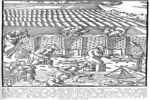 Eine Schwarz-Weiß-Zeichnung einer Gruppe von Menschen, die in einer Fabrik arbeiten, mit einem Haus im Hintergrund und einem Text unten, der lautet: "A.B.C. Drei Öfen stehen am Ersten der Schmelzer."