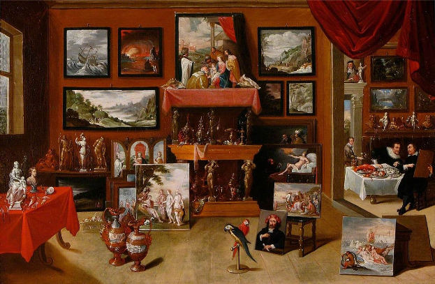Gemälde mit dem Titel "Das Künstleratelier" von Jan van Eyck, das einen Raum mit vielen Rahmenbildern an den Wänden, ein Fenster auf der linken Seite, einen Vorhang auf der rechten Seite, mehrere Personen auf Stühlen und einige auf dem Boden sitzend und einen zentralen Tisch mit Skulpturen und Gegenständen zeigt.
